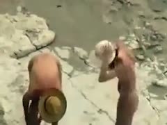 On the seashore, a lustful, dark-brown dilettante nympho swallowed her man's knob.